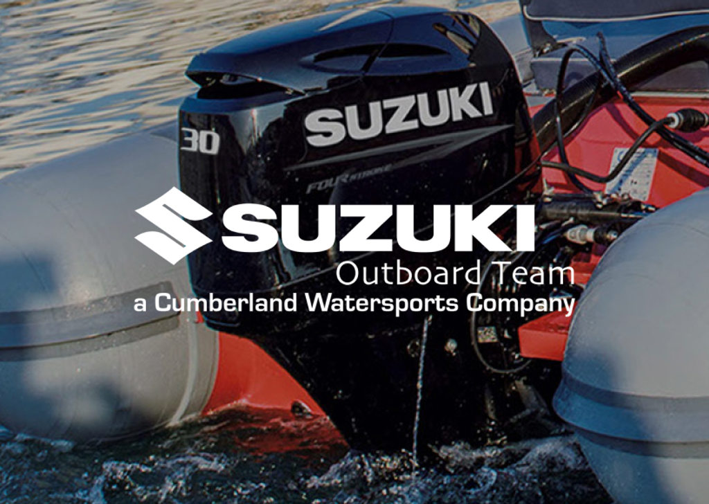 Photo of a Suzuki outboard boat motor with the Suzuki Outboard Team logo on top
